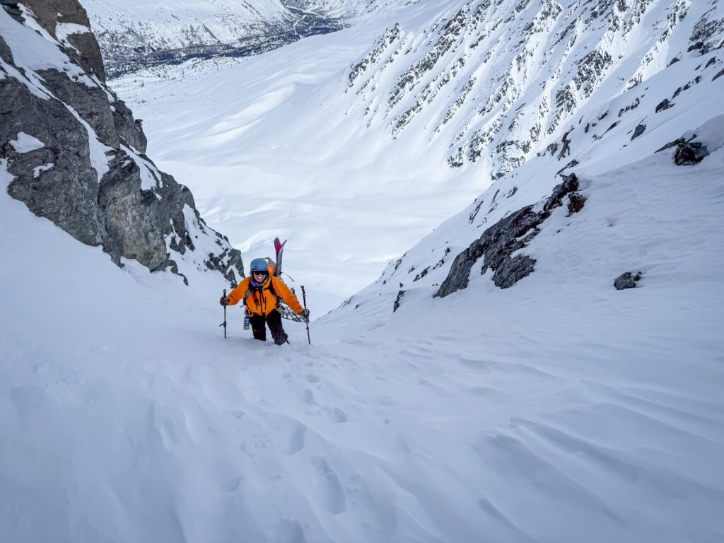 A ski mountaineer ascends a couloir in search of ski turns in the mountains.