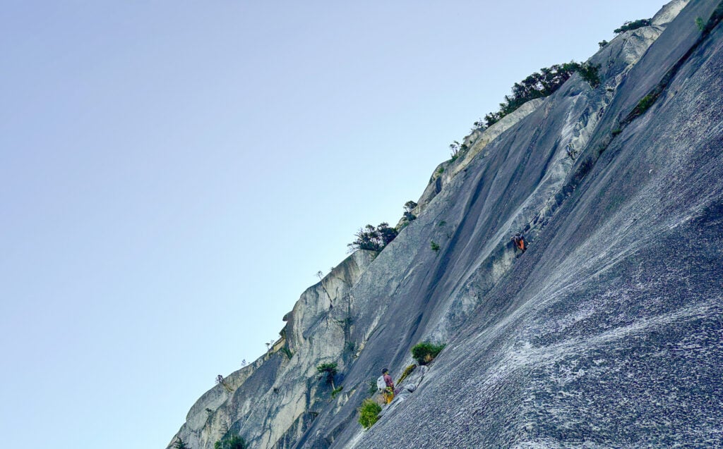 Climbers on route on the Chief in Squamish, BC during an American Alpine Institute rock climbing program