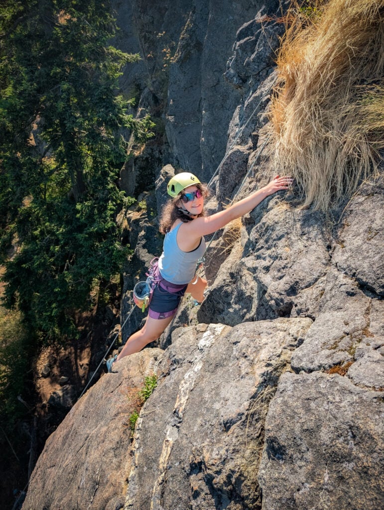 A climber nears the top of the rock route at Mt. Erie on an American Alpine Institute rock climbing program