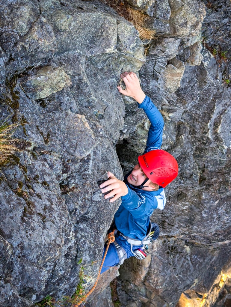 A student reaches for the next hold on an American Alpine Institute Leaders of Tomorrow Rock Climbing Camp