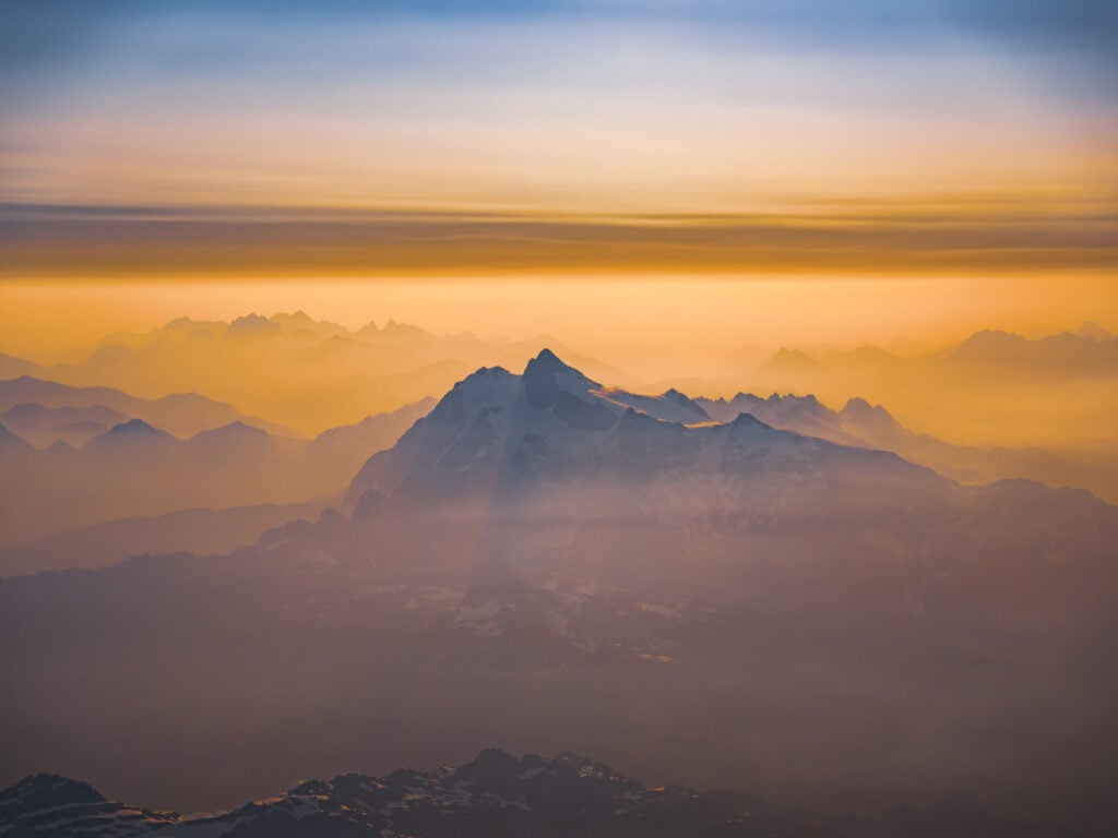 Dreamy Mt. Shuksan in the glow of sunrise as seen from Mt. Baker's summit taken during an American Alpine Institute mountaineering program