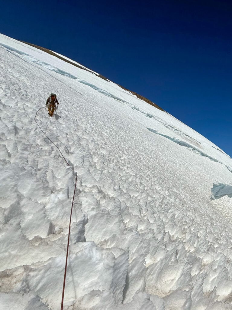 A climber navigates a slope of penitentes on the Kautz route on Mt. Rainier during an American Alpine Institute mountaineering course