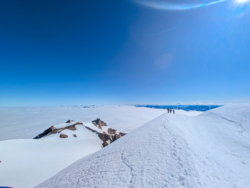 Climbers above a sea of clouds on Glacier Peak on an American Alpine Institute mountaineering course