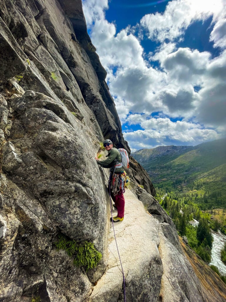 A rock climbing student a belay ledge in Leavenworth, WA during an American Alpine Institute rock climbing course