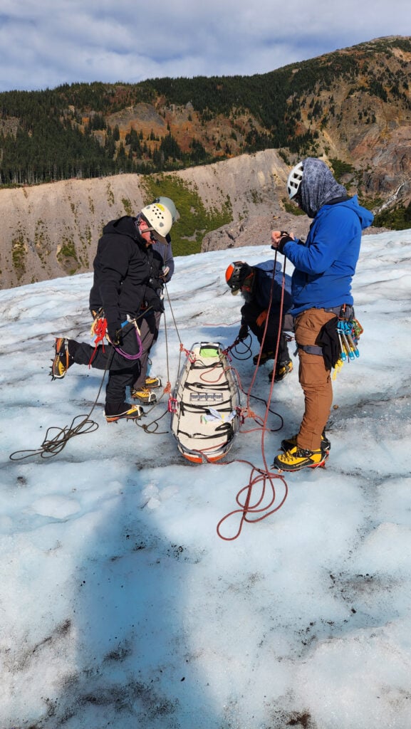 Students set up a litter on the glacier of Mt. Baker on an American Alpine Institute rope rescue program
