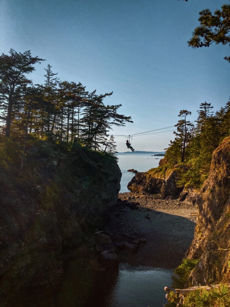 A rescuer hangs above a cove on an advanced rope rescue system on an American Alpine Institute rope rescue program
