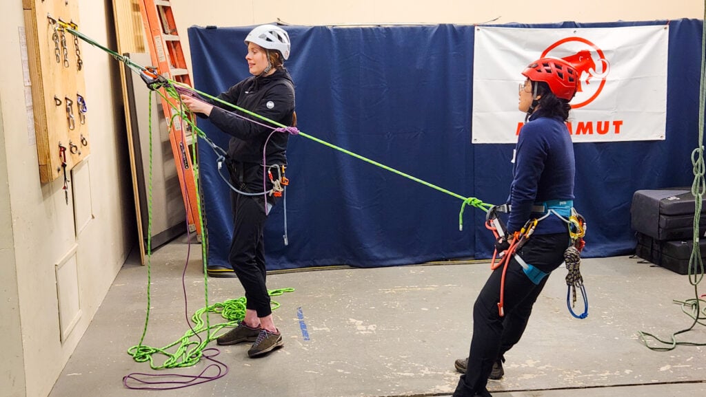 Students learn rope rescue skills in the Mountain Center classroom at the American Alpine Institute on a rope rescue course