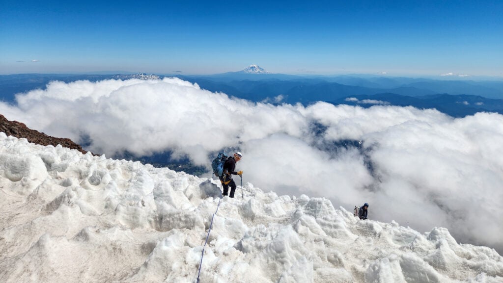 Rising above a sea of clouds on the Kautz Route of Mt. Rainier during an American Alpine Institute mountaineering program