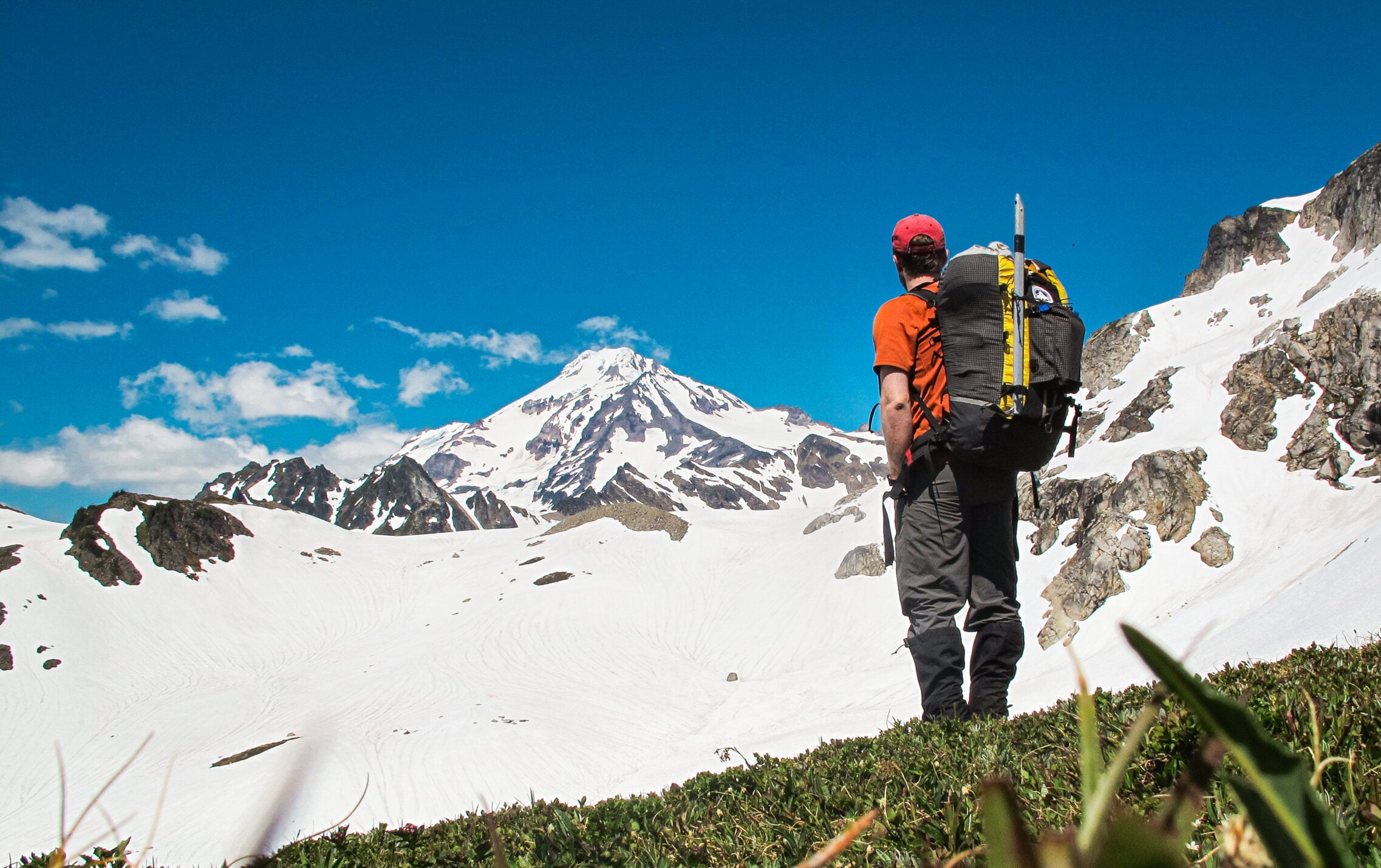 A climber looks on at the summit of Glacier Peak during an American Alpine Institute mountaineering course