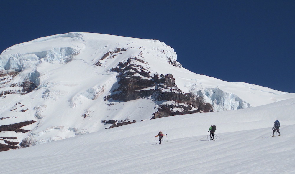 Crevasse Rescue for Backcountry Skiers and Splitboarders 1 roped up skiers skinning up the coleman glacier of mt baker